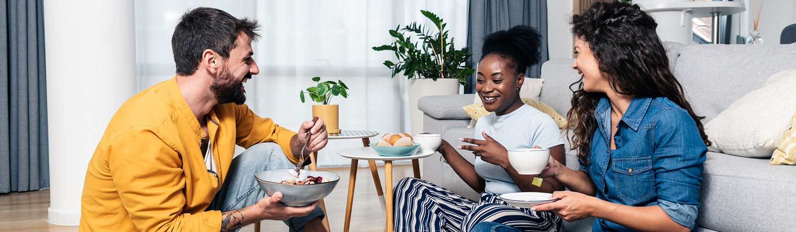 Group of young adults sharing a meal together at home