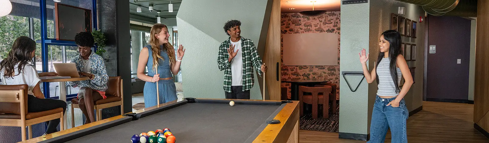Friends playing billiards